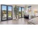 Bedroom has multiple french doors with stunning views, a potted plant and a comfortable chair at 1529 Villa Rica Dr, Henderson, NV 89052