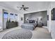 Bedroom featuring a large dresser, ceiling fan, and accent wall with windows at 1529 Villa Rica Dr, Henderson, NV 89052