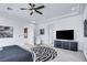 Neutral bedroom includes black dresser, accent chair and a colorful print on the wall at 1529 Villa Rica Dr, Henderson, NV 89052