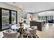 Dining area with stylish decor, a glass table, and a view of the kitchen and outdoor patio at 1529 Villa Rica Dr, Henderson, NV 89052