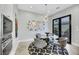 Stylish dining area with modern lighting, a glass table, and access to an outdoor space at 1529 Villa Rica Dr, Henderson, NV 89052