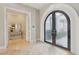 Foyer featuring marble floors, an arched doorway, and stylish decor with frosted glass doors at 1529 Villa Rica Dr, Henderson, NV 89052