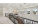 Elegant upper hallway with decorative lighting, carpet, and staircase with black railings at 1529 Villa Rica Dr, Henderson, NV 89052