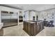 Modern kitchen with stainless steel refrigerator and appliances and gray island with cooktop at 1529 Villa Rica Dr, Henderson, NV 89052