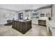 Bright kitchen featuring a center island with cooktop, white marble countertops and backsplash, and stainless appliances at 1529 Villa Rica Dr, Henderson, NV 89052