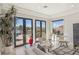 Sunlit living room with doors to an outdoor patio and pool, offering seamless indoor-outdoor living at 1529 Villa Rica Dr, Henderson, NV 89052