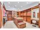 Spacious walk-in closet with custom wood shelving, drawers, and vanity with tufted bench seating at 1529 Villa Rica Dr, Henderson, NV 89052