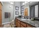 Well-lit bathroom with granite counters, vanity and dark framed mirror at 3145 E Flamingo Rd # 1045, Las Vegas, NV 89121