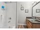 Split view of bathroom: clean tub and countertop with granite vanity and decor at 3145 E Flamingo Rd # 1045, Las Vegas, NV 89121