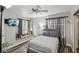 Bedroom showcasing a ceiling fan, mirrored closet doors and modern decor at 3145 E Flamingo Rd # 1045, Las Vegas, NV 89121