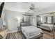 Bedroom showcasing a ceiling fan, mirrored closet doors and modern decor at 3145 E Flamingo Rd # 1045, Las Vegas, NV 89121