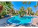 Gorgeous pool and lounge area surrounded by lush landscaping and palm trees at 3145 E Flamingo Rd # 1045, Las Vegas, NV 89121