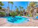 Inviting community pool with ample seating and tropical landscaping around it at 3145 E Flamingo Rd # 1045, Las Vegas, NV 89121