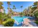 Resort-style pool area with palm trees, lounge chairs, and clear blue water at 3145 E Flamingo Rd # 1045, Las Vegas, NV 89121