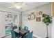 Dining area with teal chairs and a patio door leading outside at 3145 E Flamingo Rd # 1045, Las Vegas, NV 89121