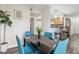 Dining area with teal chairs, black table, and kitchen access at 3145 E Flamingo Rd # 1045, Las Vegas, NV 89121