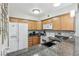 Well-lit kitchen featuring a breakfast bar, granite countertops, and ample cabinet space at 3145 E Flamingo Rd # 1045, Las Vegas, NV 89121