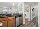 Kitchen featuring a sink, wooden cabinets, stainless steel appliances, and an open doorway at 3145 E Flamingo Rd # 1045, Las Vegas, NV 89121