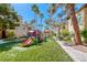 Community playground with colorful slides and play equipment on a grassy surface at 3145 E Flamingo Rd # 1045, Las Vegas, NV 89121