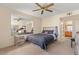 Inviting bedroom with a large wall mirror, a ceiling fan, and a cozy bed at 3425 E Russell Rd # 240, Las Vegas, NV 89120