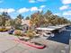 Exterior view showcasing community buildings and covered parking, plus mature landscaping and parking spaces at 3425 E Russell Rd # 240, Las Vegas, NV 89120