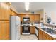 Well-equipped kitchen with stainless steel sink, tiled backsplash, and white appliances at 3425 E Russell Rd # 240, Las Vegas, NV 89120