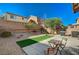 Backyard featuring a dining table and a grill and a small patch of turf at 4727 Sweeping Glen St, Las Vegas, NV 89129