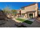 A private backyard features a patio, grill, synthetic grass and low-maintenance desert landscaping at 4727 Sweeping Glen St, Las Vegas, NV 89129