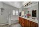 Bright bathroom featuring a double vanity, bathtub, and separate shower at 4727 Sweeping Glen St, Las Vegas, NV 89129