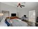 Spacious bedroom with hardwood floors and a ceiling fan and attached bathroom at 4727 Sweeping Glen St, Las Vegas, NV 89129