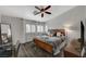 Comfortable bedroom with a ceiling fan and a large bed with wood-look flooring at 4727 Sweeping Glen St, Las Vegas, NV 89129