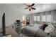 Bedroom with hardwood floors, ceiling fan, shutters, and a view to the bathroom at 4727 Sweeping Glen St, Las Vegas, NV 89129