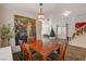 Dining room with a rustic wooden table, seasonal decorations, and seamless flow to the living area at 4727 Sweeping Glen St, Las Vegas, NV 89129