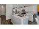 Bright kitchen features white cabinets, stainless steel appliances, and a center island with marble countertops at 4727 Sweeping Glen St, Las Vegas, NV 89129