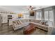Spacious living room featuring a large sectional sofa, ceiling fan, and access to an open kitchen at 4727 Sweeping Glen St, Las Vegas, NV 89129