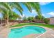 Inviting backyard oasis featuring a sparkling pool, lush landscaping, and a relaxing hammock at 5484 Oatfield St, North Las Vegas, NV 89081