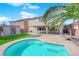 Landscaped backyard with pool and covered patio at 5484 Oatfield St, North Las Vegas, NV 89081