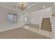 Spacious dining area with high ceilings, chandelier, and neutral decor at 5484 Oatfield St, North Las Vegas, NV 89081