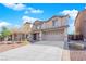 Two-story house with a beige exterior, two-car garage, and landscaping at 5484 Oatfield St, North Las Vegas, NV 89081