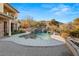 Inviting pool with a waterfall feature and mountain backdrop at 62 Golf Estates Dr, Las Vegas, NV 89141