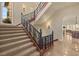 Elegant staircase with wrought iron railing leading to upper level at 62 Golf Estates Dr, Las Vegas, NV 89141