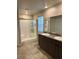 Bright bathroom featuring double sinks with granite countertop and glass-enclosed shower at 7544 Pink Mimosa Ave, Las Vegas, NV 89113