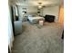 Expansive carpeted main bedroom with windows, blinds, and ceiling fan at 7544 Pink Mimosa Ave, Las Vegas, NV 89113