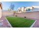 Artificial turf backyard with block wall at 9936 Coyote Echo Ct, Las Vegas, NV 89166