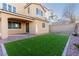 Artificial turf backyard with covered patio at 9936 Coyote Echo Ct, Las Vegas, NV 89166