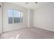 Well-lit bedroom with carpet flooring and large window at 9936 Coyote Echo Ct, Las Vegas, NV 89166