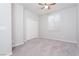 Bright bedroom with carpet flooring, double door closet, and window coverings at 9936 Coyote Echo Ct, Las Vegas, NV 89166