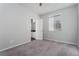 Bright bedroom with plush carpet, ceiling fan, and ensuite bathroom access at 9936 Coyote Echo Ct, Las Vegas, NV 89166