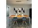 Elegant dining room with modern light fixture and wood table at 9936 Coyote Echo Ct, Las Vegas, NV 89166