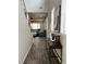 Bright entry hall with dark wood-look tile floors and views to the living room at 9936 Coyote Echo Ct, Las Vegas, NV 89166